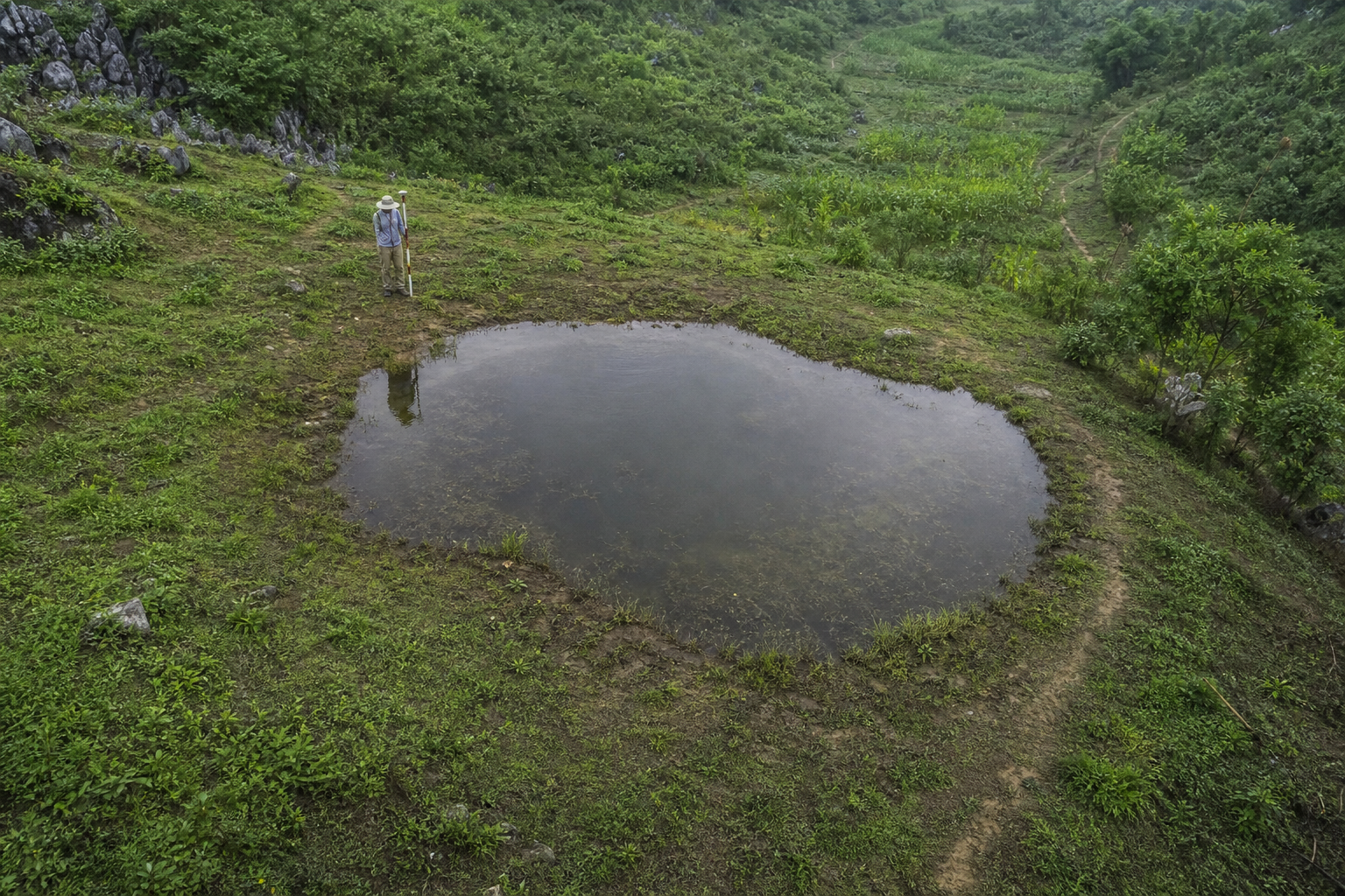 Generated raster terrain reconstruction of a roughly 15 meter Shizhu Astro-Pond set flush into flattened karst hillside terrain